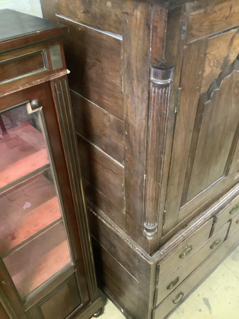 A mid 18th century oak two part bow fronted Dower chest / linen press, with doors enclosing shelves and six drawers, width 121cm